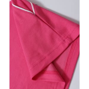 A close-up of a pink polo shirt featuring short sleeves and contrasting trim. The shirt includes a logo.