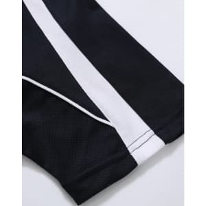 A close-up of a black polo shirt with white stripes, featuring a logo on the fabric.