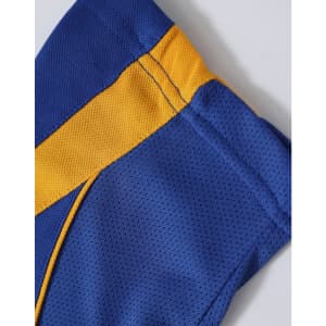 A close-up of a blue and yellow polo shirt featuring a textured design and a branded logo.