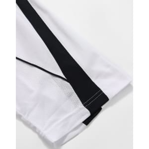 A white polo shirt featuring black detailing along the sleeves and a logo.
