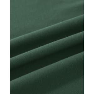 A close-up view of soft, dark green cotton fabric, featuring gentle folds and a smooth texture.