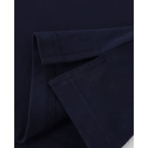 A close-up of a navy blue cotton stretch polo shirt, showcasing the fabric and folded sleeves. It features a logo.