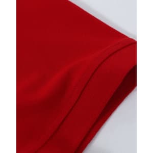 A close-up view of a red men's cotton stretch polo shirt featuring a folded sleeve. It has branding on the fabric.