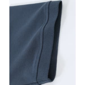 A close-up of a navy blue men's cotton stretch polo shirt, highlighting the fabric and sleeve detail.