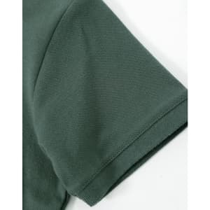 A close-up of a dark green cotton stretch polo shirt sleeve, featuring a smooth fabric texture and a logo.