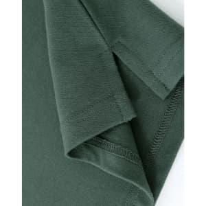 A close-up of a ladies cotton stretch polo shirt in dark green, showing the cuff and stitching details.