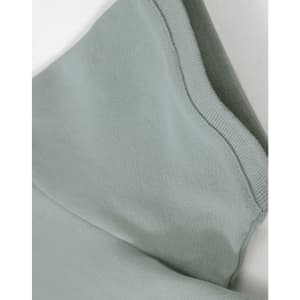 A close-up of a light green ladies cotton stretch polo, highlighting the fabric and collar details.