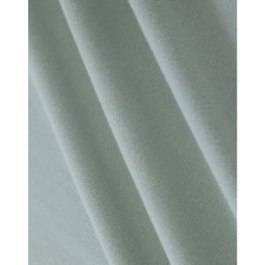 A close-up of light green cotton fabric, featuring a textured weave suitable for polo shirts.
