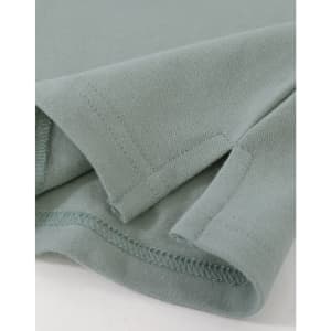 A close-up of a ladies cotton stretch polo in a soft green colour, highlighting the fabric and stitching details.