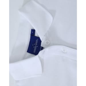 A white ladies cotton stretch polo shirt featuring a collar and button placket, with a brand label inside.