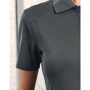 A grey polo shirt with a textured fabric and a collar, featuring a subtle logo.