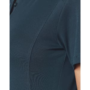 A close-up of a teal polo shirt featuring a collar and a textured fabric. The shirt has a small logo.