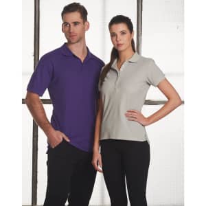 A man in a purple polo shirt and a woman in a grey polo shirt, both with collars, standing side by side.