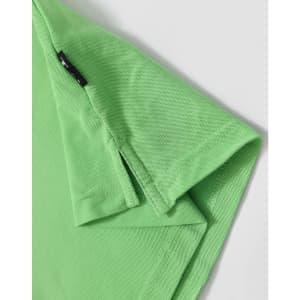 A green polo shirt featuring a logo and a textured fabric. Close-up of the collar and sleeve hem.