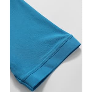 A close-up of a turquoise polo shirt sleeve, showcasing its textured fabric and cuff detail.