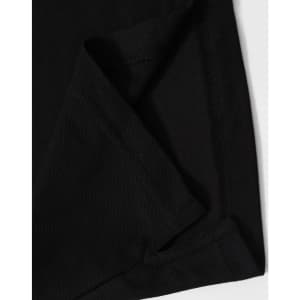 A close-up of black fabric showcasing a folded corner, featuring stitching details and a hidden pocket.