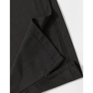 A close-up of a black polo shirt featuring a neatly stitched hem and collar. The fabric texture is visible.