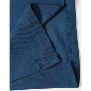 A folded section of a navy blue polo shirt featuring stitching details and a logo.