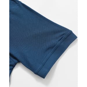 A close-up of a blue polo shirt sleeve with a smooth texture and cuff detail, featuring a logo.