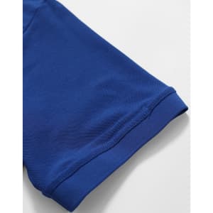 A close-up of a blue polo shirt sleeve featuring a smooth hem and textured fabric. The shirt has a logo on it.