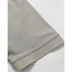 A close-up of a light grey polo shirt sleeve, featuring a solid hem and a smooth fabric texture.