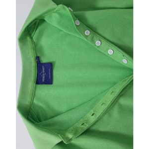 A green Ladies' Truedry Pique Polo shirt features a polo collar and button detail, with a brand label visible.