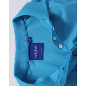 A light blue polo shirt featuring a collar and button placket, with a branded label inside.