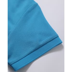 A close-up of a turquoise polo shirt sleeve, featuring a textured fabric and a logo.