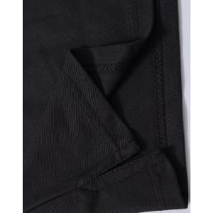 A close-up of black fabric showing the folded edge and stitching detail of a polo shirt. The fabric has a textured finish.
