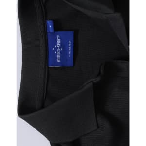 A black polo shirt with a collar and a tag featuring a logo.