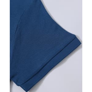 A close-up of a blue polo shirt sleeve, showcasing the textured fabric and stitched details. The shirt has a logo.