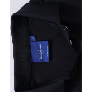 A black polo shirt featuring a collar and a label inside with branding.
