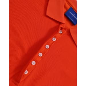 An orange polo shirt with a collar and a button placket. It features a branding label on the inside.