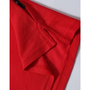 A red ladies' polo shirt displayed close-up, highlighting the collar and sleeve details. The shirt features a logo.