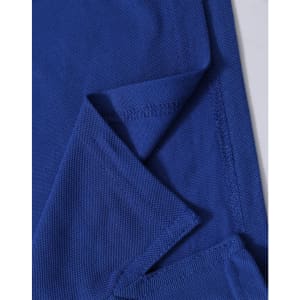 A blue polo shirt featuring a textured fabric with a folded sleeve detail and a branding logo.