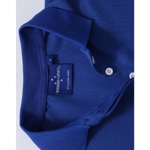 A close-up of a blue polo shirt, featuring a classic collar and buttons, with a label and a logo on the inside.