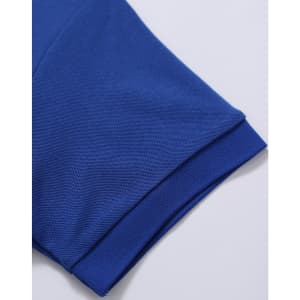 A close-up of a blue polo shirt featuring a textured fabric and rolled sleeves. The shirt has a logo.