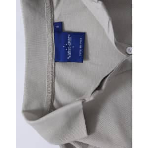 A grey Ladies' Truedry Pique Polo with a collar and buttons, featuring a logo tag inside the neckline.