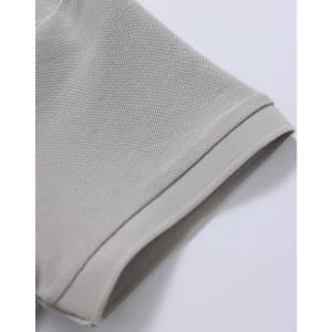 A close-up of a light grey polo shirt's sleeve, showcasing the pique texture and stitch detailing.
