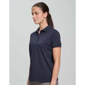 A navy ultrafine cotton pique polo with a collared neckline, displayed on a model. The shirt has a logo on it.