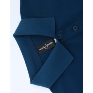 A navy blue ladies polo shirt with a collared neckline and buttons, featuring a brand tag inside.