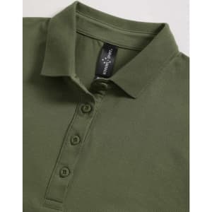 A green ladies polo shirt with a collared neck and a button placket, featuring a logo tag inside.