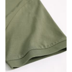 A close-up of a khaki green ultrafine cotton pique polo shirt, featuring a hem and sleeve detail.
