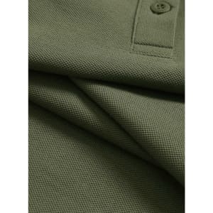 A close-up of an olive green ultrafine cotton pique polo shirt featuring a button and textured fabric.