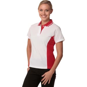 A white and red Ladies' TrueDry Contrast short-sleeve polo shirt displayed on a model, featuring a logo.