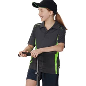 A child wearing a dark grey polo shirt with lime green contrast details, standing next to a scooter.