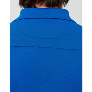 A close-up view of the back of a men's polo shirt in vibrant blue, featuring a collar and a branding label.