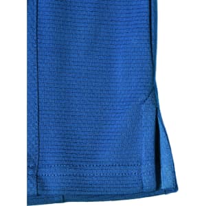 A blue bamboo charcoal polo shirt featuring a textured pattern and side slits, with a logo.