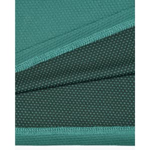A fabric close-up of a teal bamboo charcoal polo shirt, featuring textured and dotted patterns.