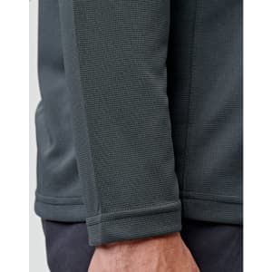 A close-up of a men's long sleeve polo shirt in dark grey, featuring a textured fabric and a logo.
